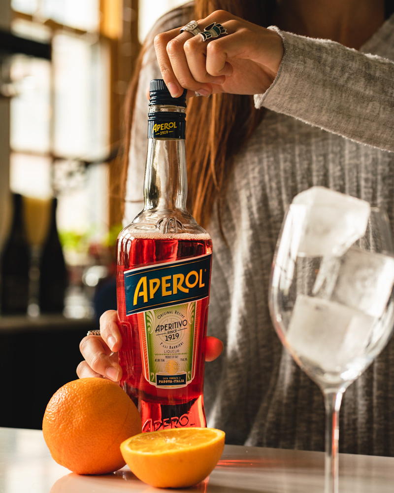 Opening a bottle of Aperol