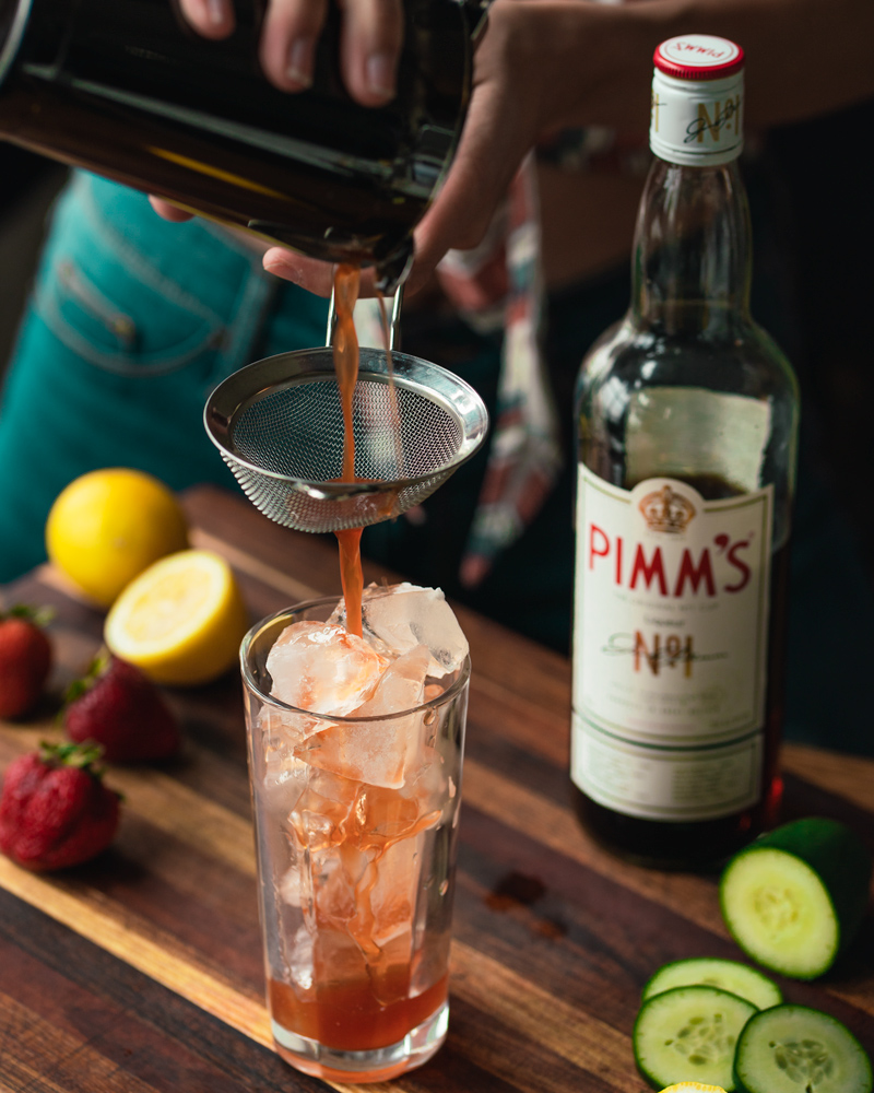 Straining the Pimms and fruit